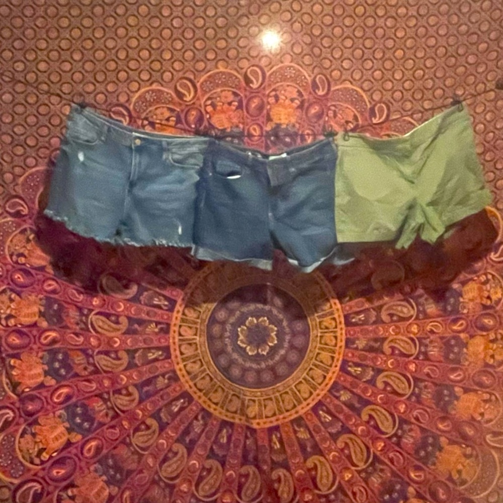 2 pairs of Jean shorts and a pair of green cotton shorts.